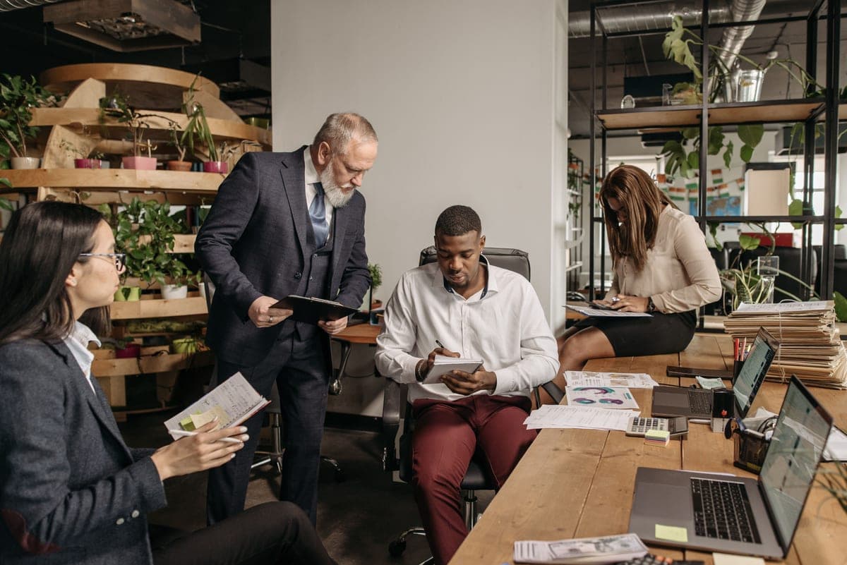 A team reviewing notes together around an office desk