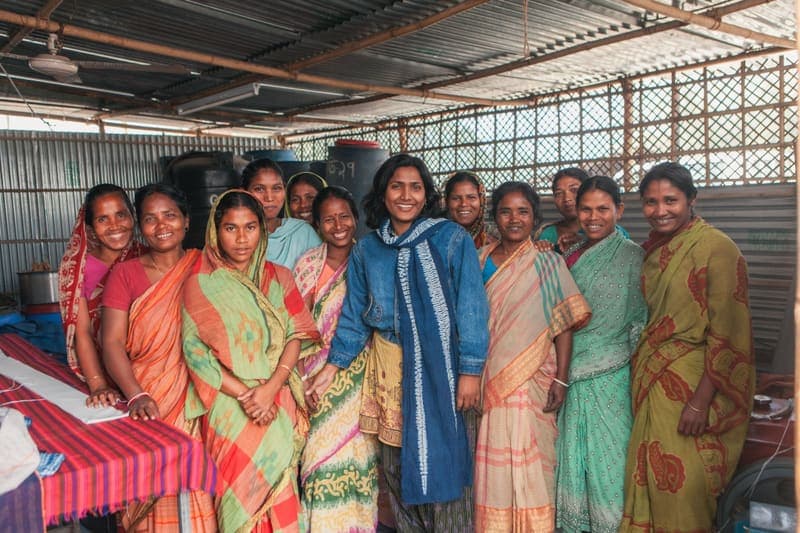 A group of smiling women standing together in a workshop